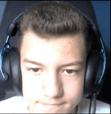 a young boy wearing headphones with a blue headband