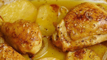 a close up of a chicken and potatoes in a casserole dish .