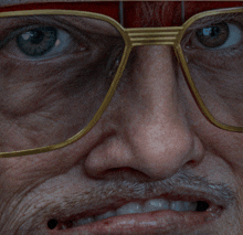 a close up of a man 's face wearing glasses and a red headband