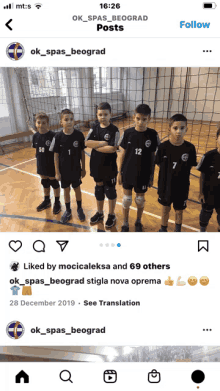 a group of young boys standing on a volleyball court with their arms crossed in front of a net