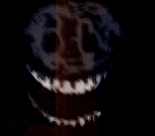 a glowing face is visible in the dark