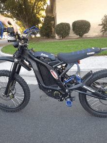 a black dirt bike with a dunlop sticker on it