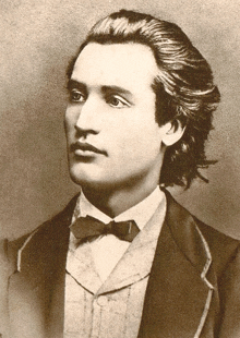 a young man in a suit and bow tie