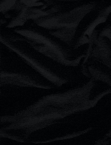 a close up of a black cloth with waves on it .