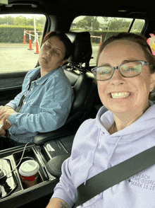 two women in a car one wearing a hoodie that says reach the gospel