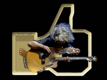 a man playing an acoustic guitar in front of a gold thumbs up sign