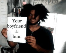 a man holds a sign that says your boyfriend a bum