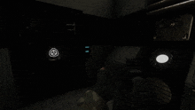 a person is holding a gun in a dark room with a scp symbol on the wall