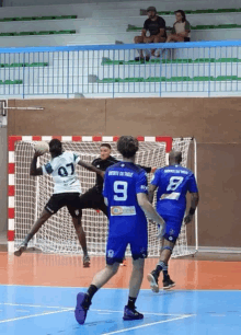 a man wearing a number 9 jersey tries to block a shot