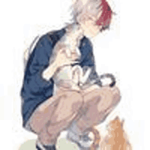 a man is kneeling down next to a cat and holding it .