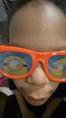 a close up of a person wearing sunglasses with a picture of a cartoon character on them