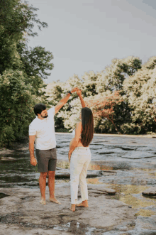 a man and a woman are dancing in the water