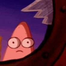 patrick star from spongebob squarepants is looking out of a window with a sad face .