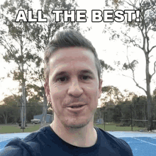 a man is taking a selfie in front of a tennis court with the words all the best above him