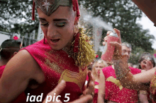 a man in a wonder woman costume is spraying glitter