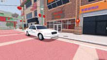 a white police car is parked in front of a dragon shop