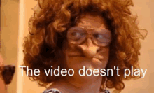 a woman wearing glasses and a wig with the words the video does n't play behind her