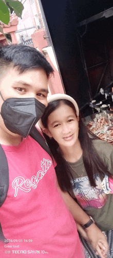 a man wearing a red regatta shirt poses with a young girl