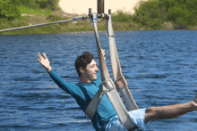 a man is flying through the air over a body of water