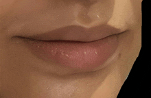 a close up of a woman 's lips with white spots on it