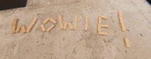 wooden blocks spell out the word wow on a concrete surface