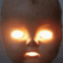 a close up of a doll 's face with bright eyes .