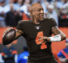 a man wearing a brown jersey with the number 4 on it throws a football