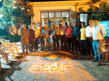 a group of men are posing for a picture in front of a building that says ' shree ram '