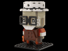 a lego model of a man with a hat and glasses