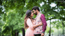 a man and a woman are looking at each other and the photo was taken by jomal photography