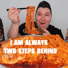 a man is eating noodles with chopsticks and the words i am always two steps behind behind him