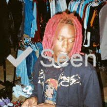 a man with pink dreadlocks is seen in a photo