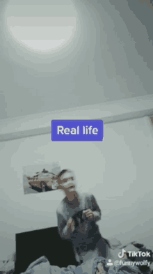 a tiktok video shows a man playing a video game with the caption real life