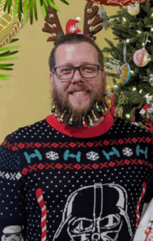 a man wearing a darth vader christmas sweater