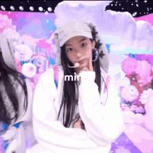 a girl wearing a bunny hat and a white sweatshirt with the word min on it