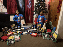 two children standing in front of a christmas tree surrounded by toys and a donut shop bag