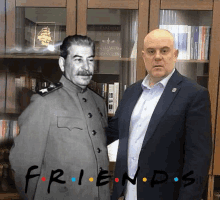 two men are standing next to each other in front of a bookcase with the words friends written in white letters