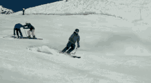 a man in a green jacket is skiing down a snowy hill