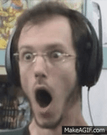 a man wearing headphones is making a surprised face with his mouth open