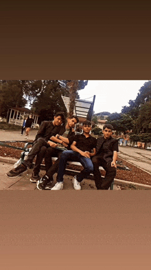 a group of young men sitting on a park bench