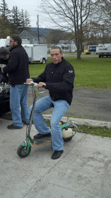 a man riding a scooter with a pepsi truck in the background