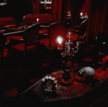 a candle is lit in a dark room next to a skull