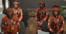 a group of people wearing orange jumpsuits and helmets with the word rescue on them