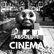 a black and white photo of a train with the words " absolute cinema " on the bottom