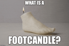 a candle in the shape of a foot with the caption " what is a foot candle ? "