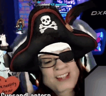 a woman wearing a pirate hat and eye patch smiles