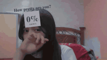 a girl covering her face with a sticker that says 0 %