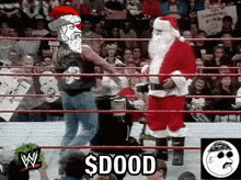 a man in a santa hat is standing in a wrestling ring with a caption that says ' $ dood '