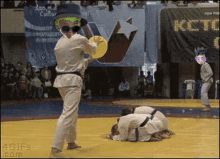 a karate match with a sign that says kct in the background