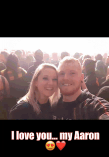 a man and a woman are posing for a picture with the words " i love you my aaron " below them